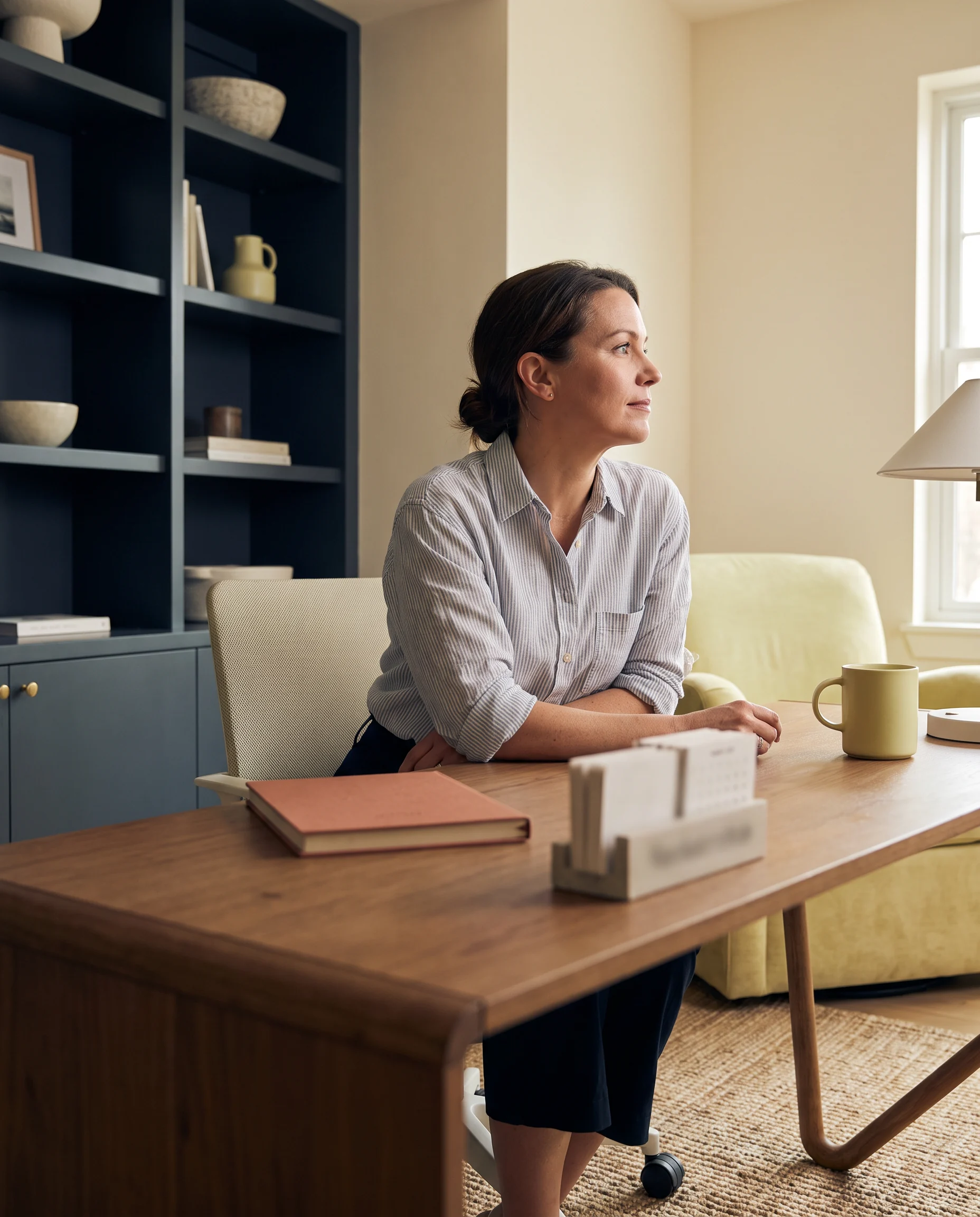 A professional sitting with a notebook at a desk